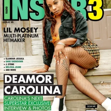 A beautiful black woman Deamor Carolina sits on steps in navy coat, long hair, plaid skirt, white and black boots, yellow top, fishnet stockings for Inspir3 Radio Magazine Issue 6 Cover