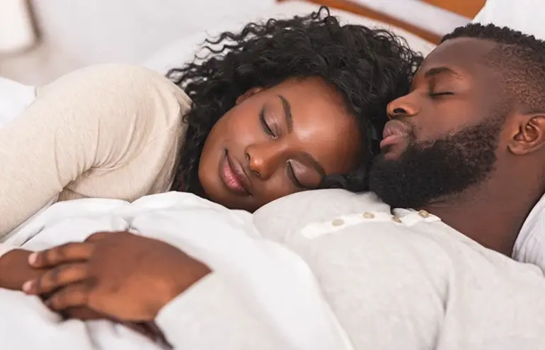 A Black Couple lay in bed together. Love Sessions Live